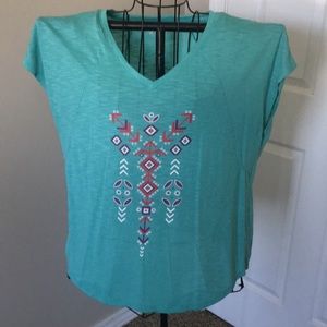 Teal shirt with arrow like designs